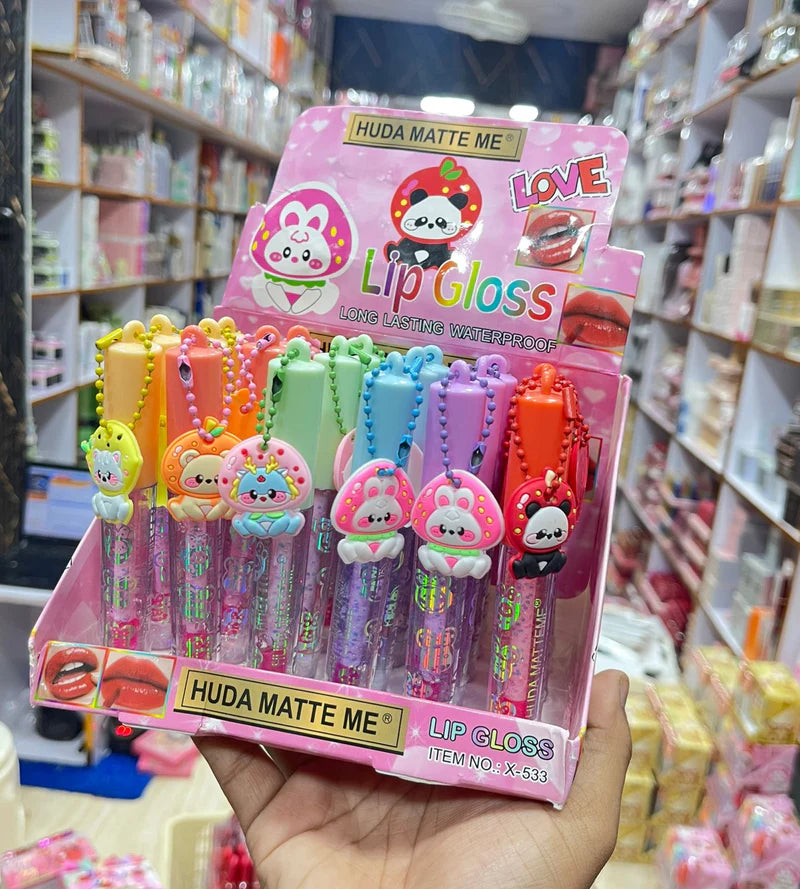 HUDA MATTE ME Lip Gloss – Cute Charm Caps, Long-Lasting Waterproof Shine (Counter Display | Item No. X-533)