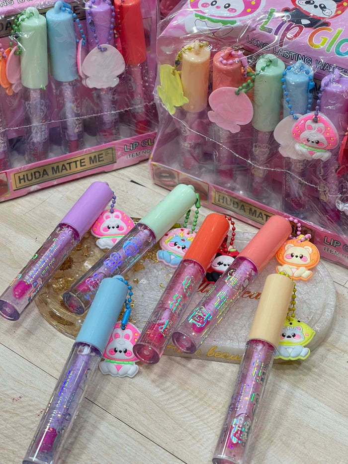 HUDA MATTE ME Lip Gloss – Cute Charm Caps, Long-Lasting Waterproof Shine (Counter Display | Item No. X-533)